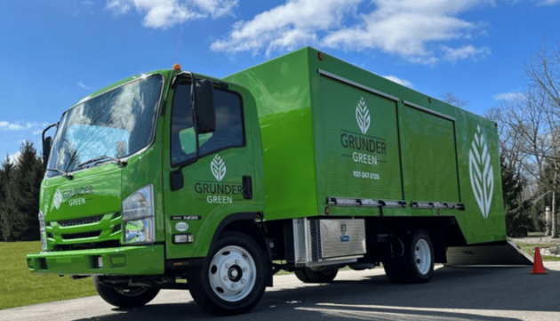 Green box truck with Grunder Greens logo on the side