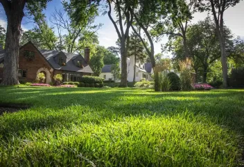Brick house with a green front lawn 
